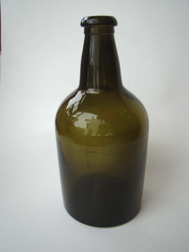A deep olive green wine bottle circa 1820.